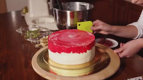 woman decorating a beautiful red and white marble swirl cake