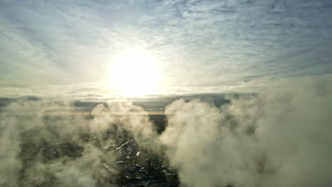 water vapor in the flue gases condenses and forms visible white clouds of steam in front of the sun