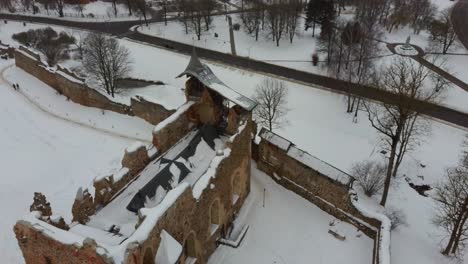 ruins of ancient livonian order's stone medieval castle latvia aerial drone top shot from above . restored castle capella at winter in dobele city. 4k resolution