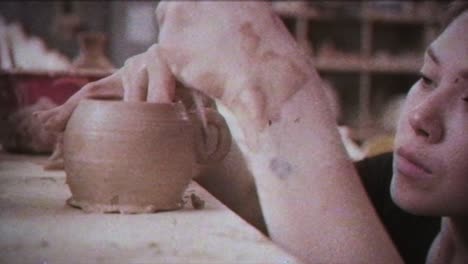 young woman makes a jug of clay. female hands mold pottery. vintage effect.