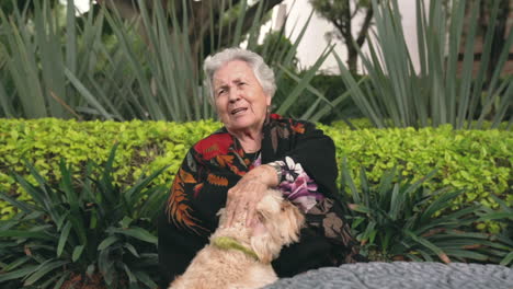 Elderly-woman-petting-dog-in-garden