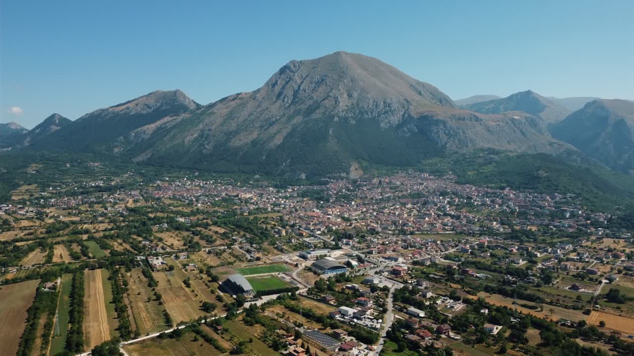 Aerial View of Town with Mountain Backdrop