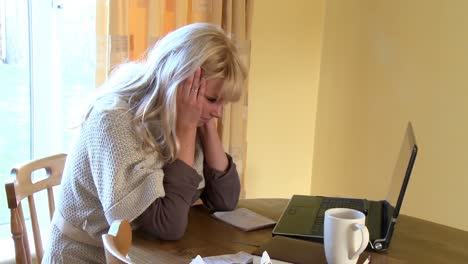 frustrated woman working at a laptop