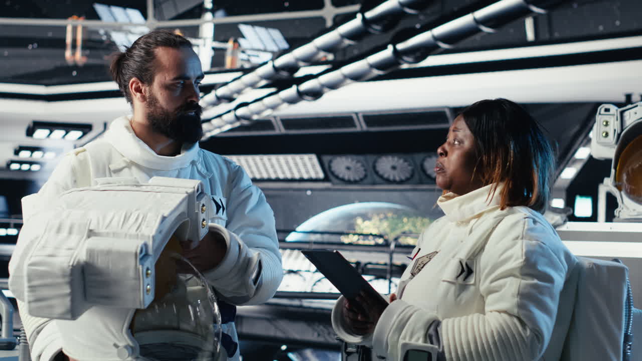 Astronaut getting mission briefing from leader before leaving space station