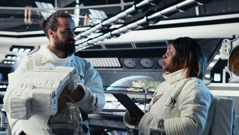 astronaut getting mission briefing from leader before leaving space station