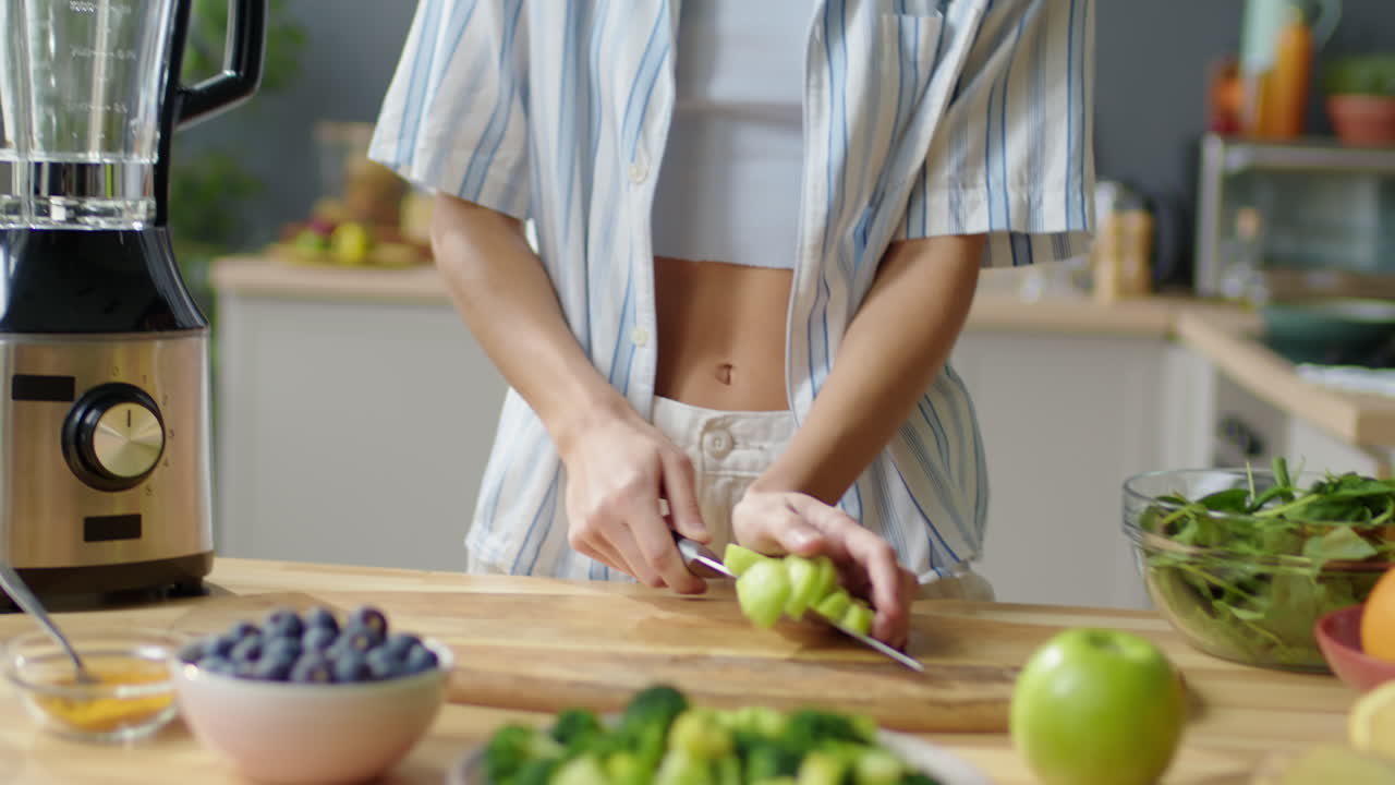 Woman Putting Fresh Fruit in Blender for Making Smoothie