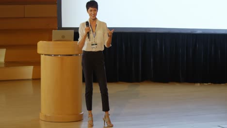 young asian businesswoman speaking in speaker on stage in auditorium 4k