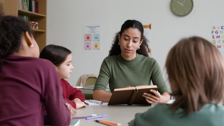 Teacher Reading to Students in Classroom