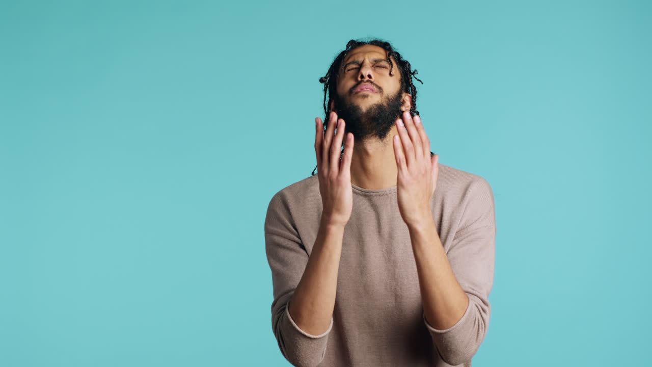Pious man praying to his god, asking for forgiveness, feeling desperate, studio
