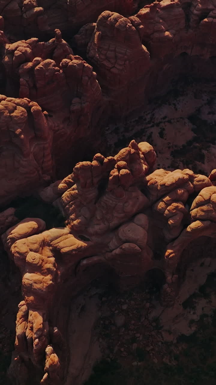 Amazing weird-shaped tops of canyons. Impressive rocks of Arches National park in Utah, USA on sunny daytime. Vertical video