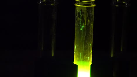 a lab tube glowing in the dark