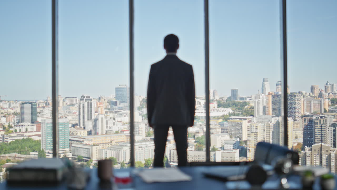 Confident leader standing office in suit looking panoramic window rear view.