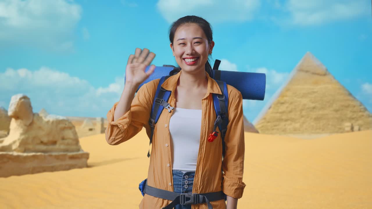 Asian Female Hiker With Mountaineering Backpack Waving Hand And Saying Bye While Traveling In Pyramid Of Giza