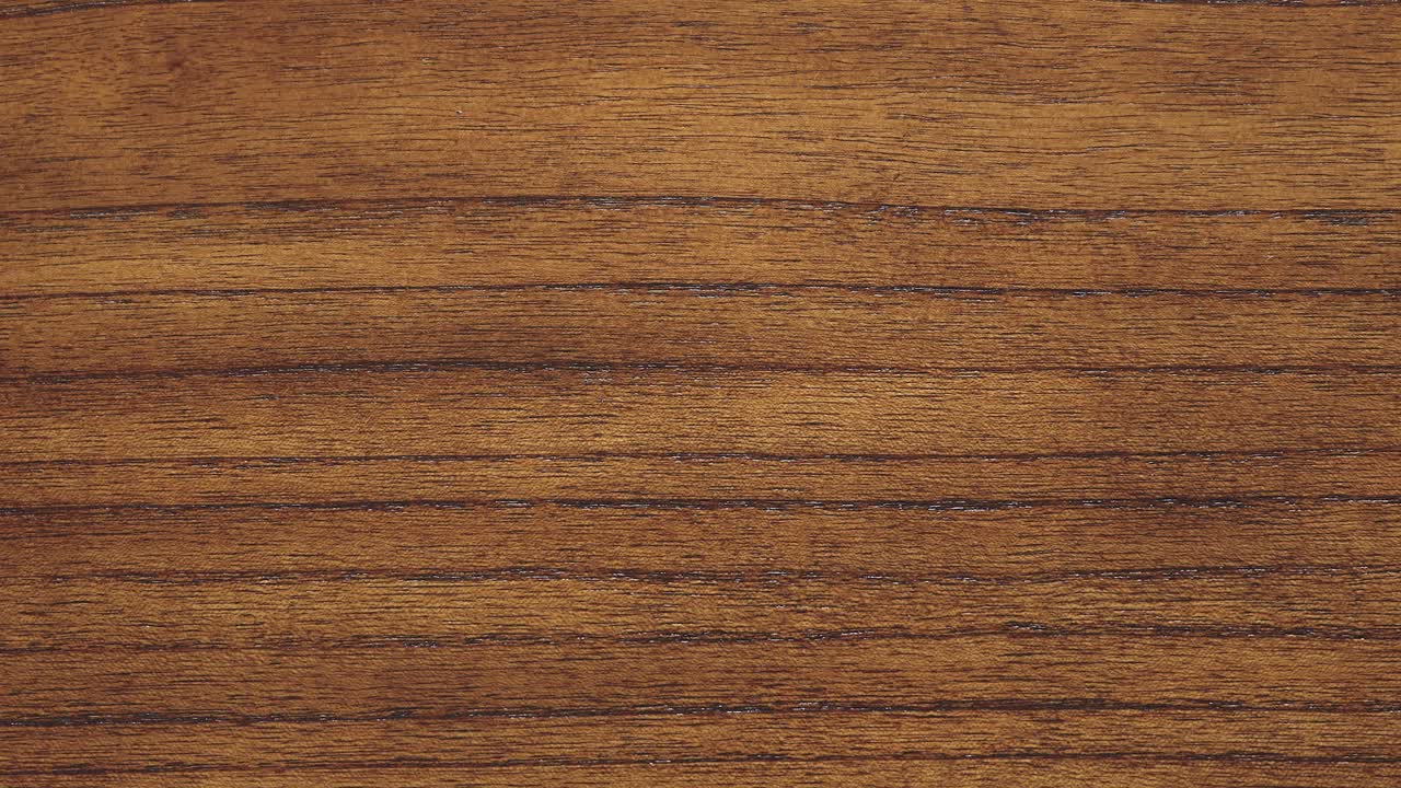 Camera rises along dense grain lines of rich timber surface