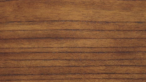 camera rises along dense grain lines of rich timber surface