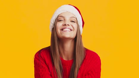 woman in santa hat blowing confetti