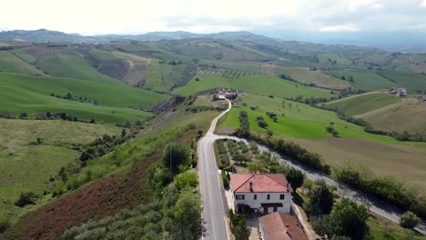 aerial flyover rotating and panning from right to left of a hilly field landscape