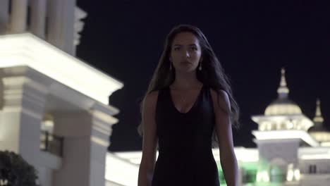 woman in a black dress at night