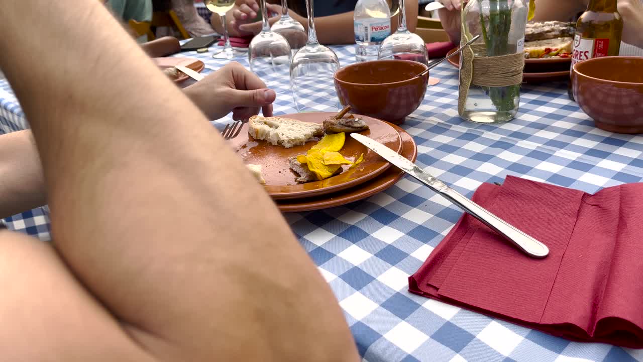 Amid Lisbon's Santo Ant&oacute;nio celebration, a man savors a &amp;quot;febra&amp;quot; with gusto, embracing the festive spirit and culinary delights