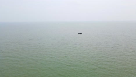 fishing boat trawler on sea in a gloomy weather - aerial drone shot