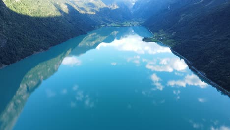 flying towards briksdalsbreen glacier over oldevatnet lake in norway