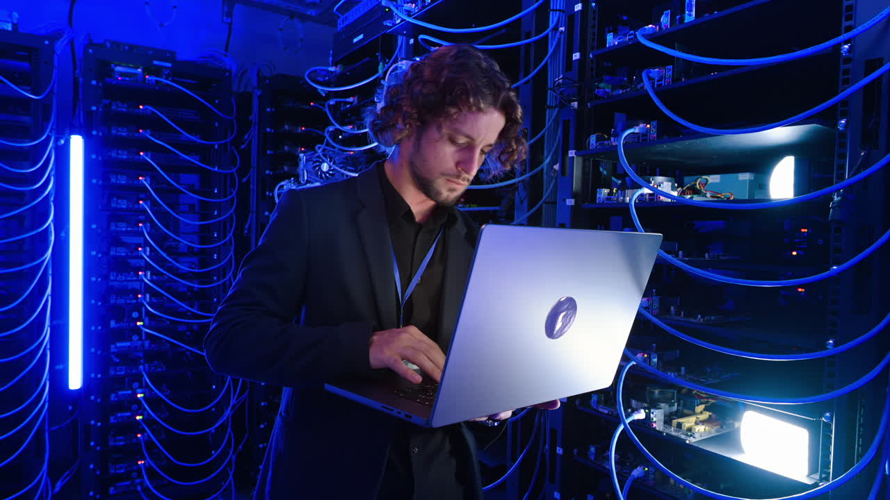 Man analysing data in a server room
