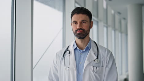 professional doctor standing hospital hallway closeup. serious bearded physician
