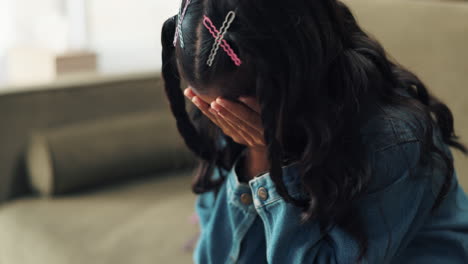 sad girl covering her face with her hands