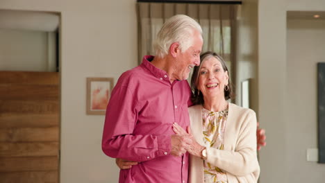 happy senior couple embracing at home, enjoying festive holiday moments together