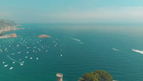 Aerial-reveal-of-Medieval-Castle-in-Costa-Brava-Village,-Tossa-de-Mar-in-Catalonia,-Spain