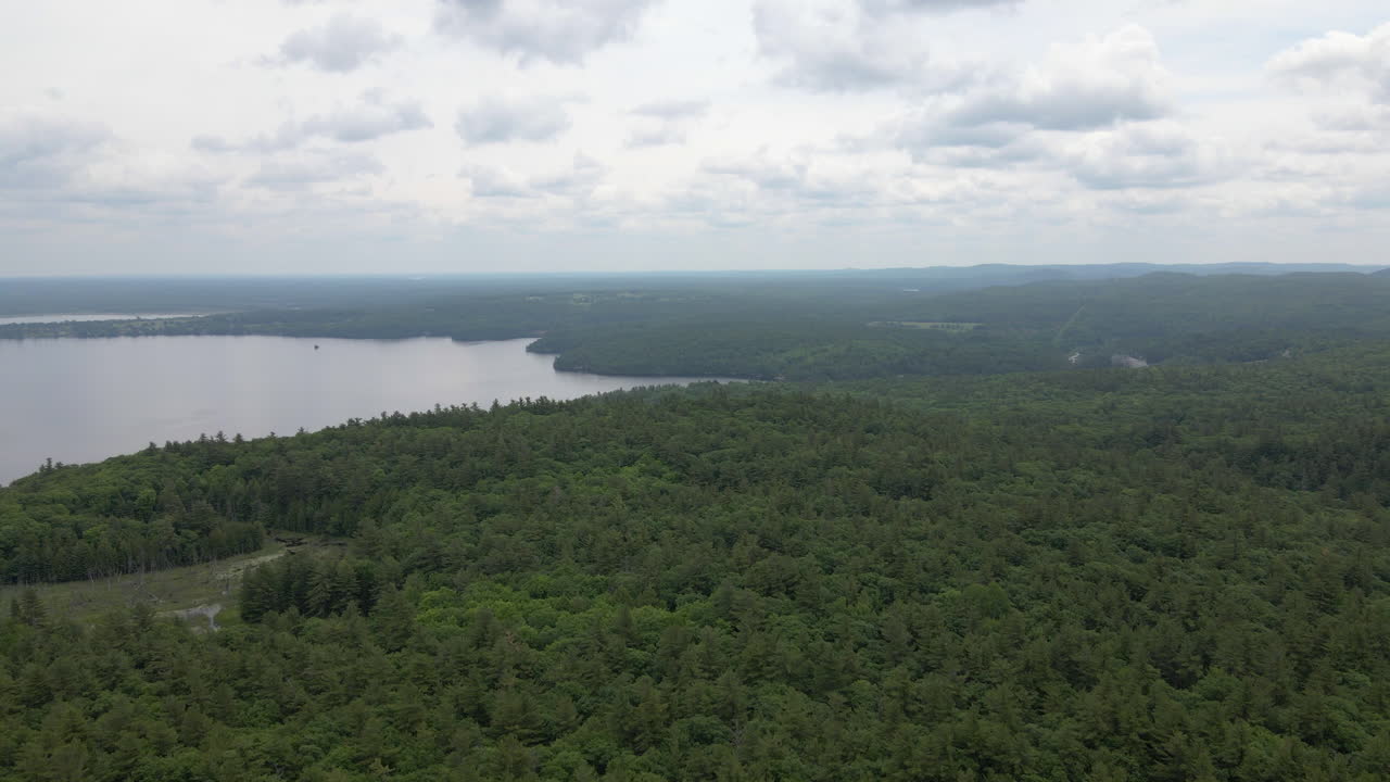 aerial shot over tree covered mountainside and lake Calabogie. Ontario Canada Ski hill, Summer