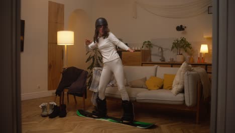 woman practicing snowboarding indoors