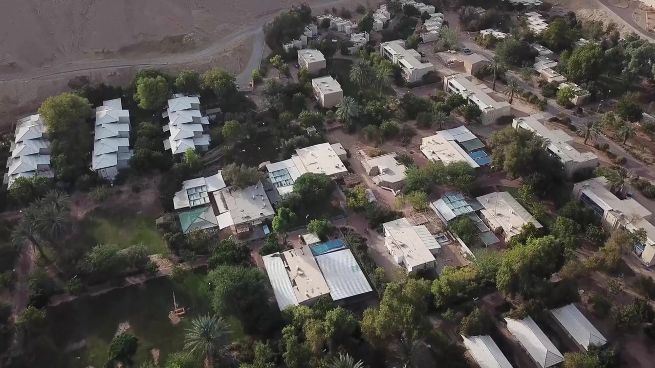 Aerial: drone view over the rooftops of the village of Yotvata, Israel