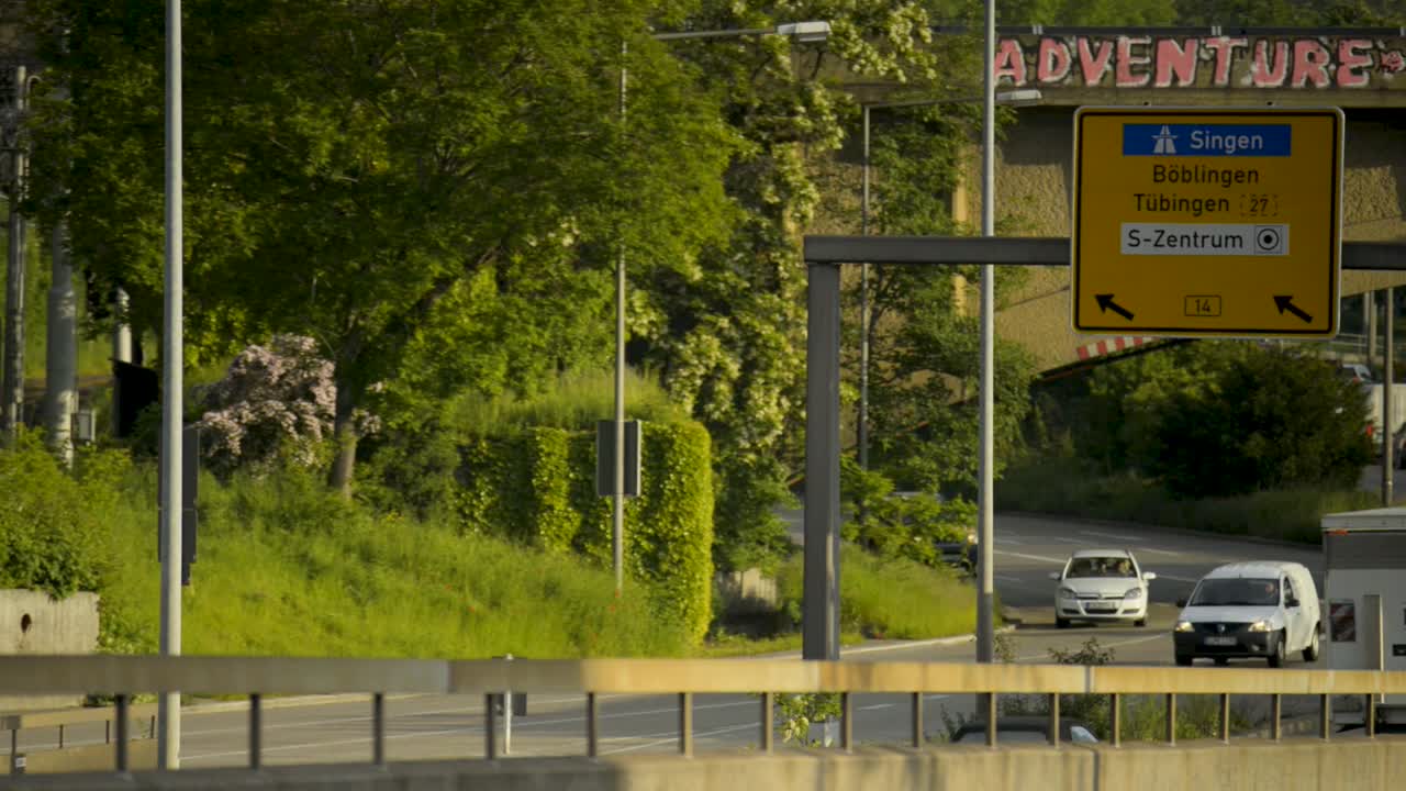 Heavy traffic on a city road during rush hour with various road signs and vehicles