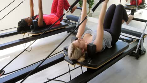 women exercising on rowing machine 4k