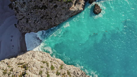 ocean waves crashing on shoreline of sa calobra beach in mallorca, spain