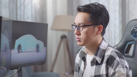 man focused on 3d car design on computer