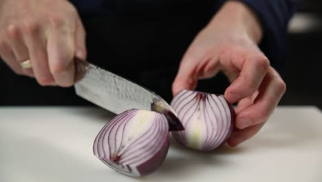 chef cutting an onion