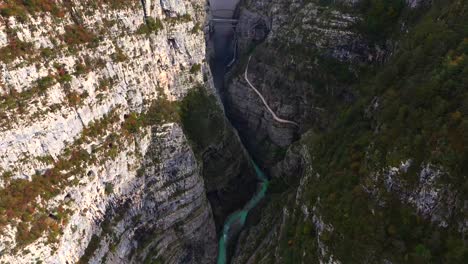 aerial view of a canyon with a dam and bridge