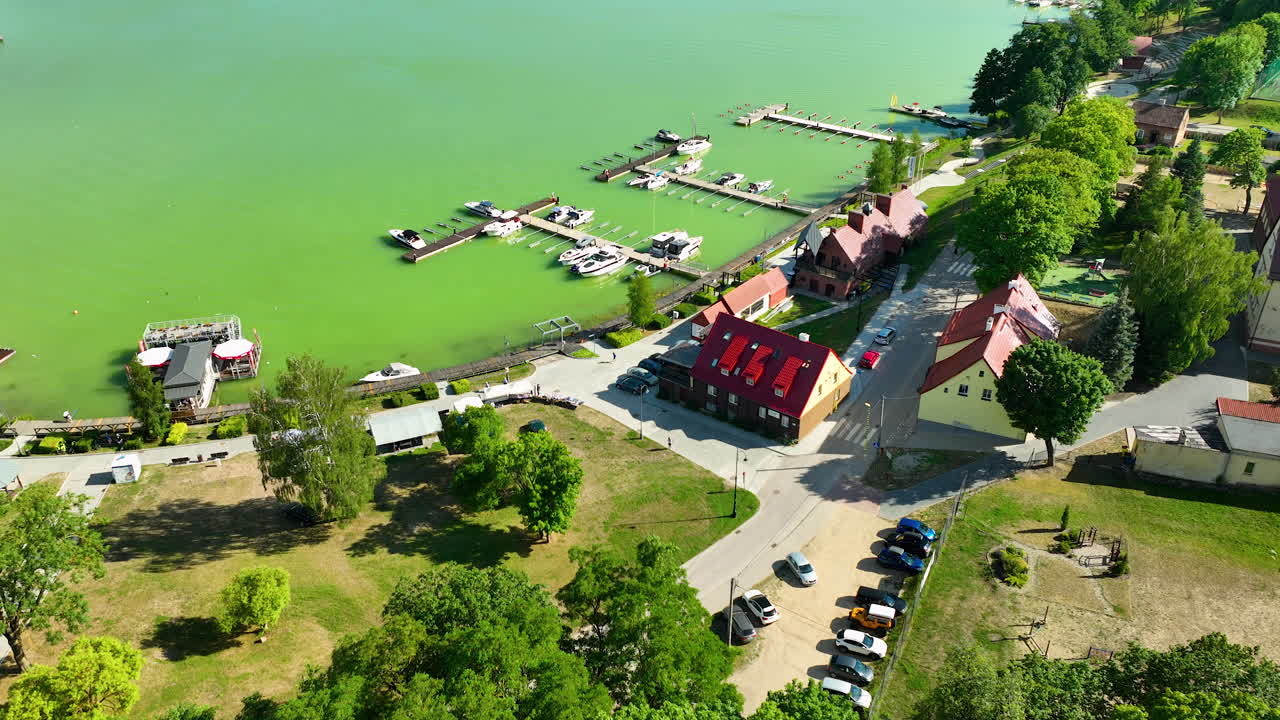 Aerial view of a marina on a lake with boats and surrounding buildings