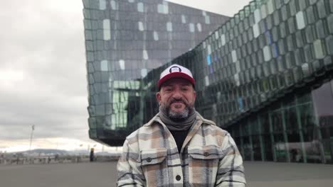 man taking a selfie at the harpa in reykjavík