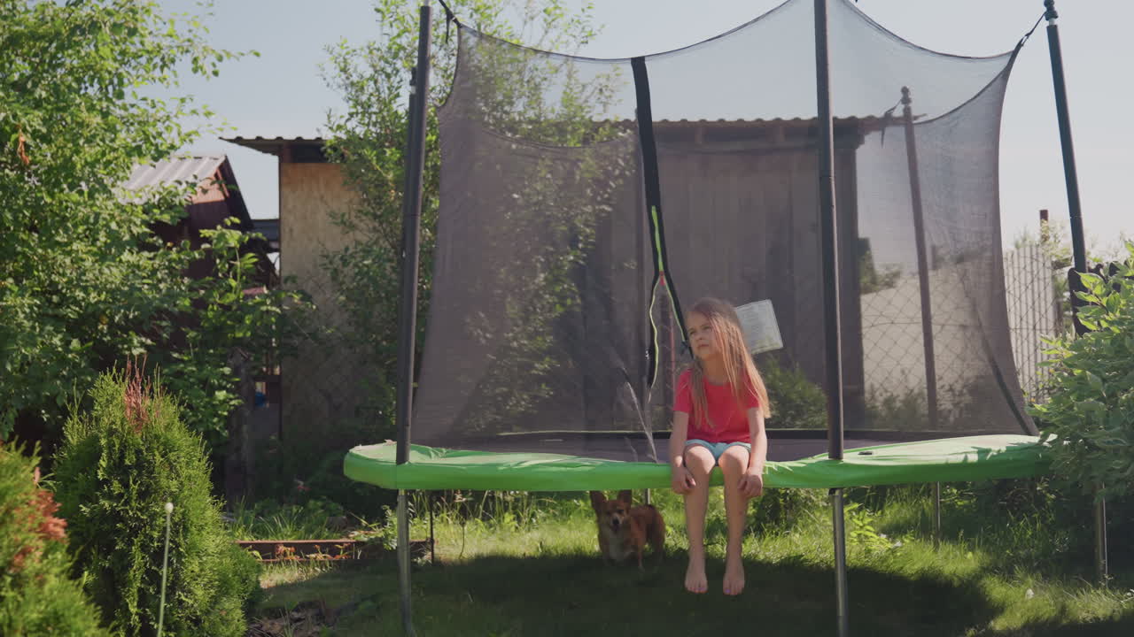 Girl Sitting On Trampoline Holding Basket In Shaded Garden, Calm Stillness And Thoughtful Posture, Bright Summer Light Filtering Through Trees, Intimate Outdoor Portrait With Leafy Backdrop