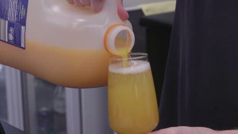 adding orange juice to a glass of wine