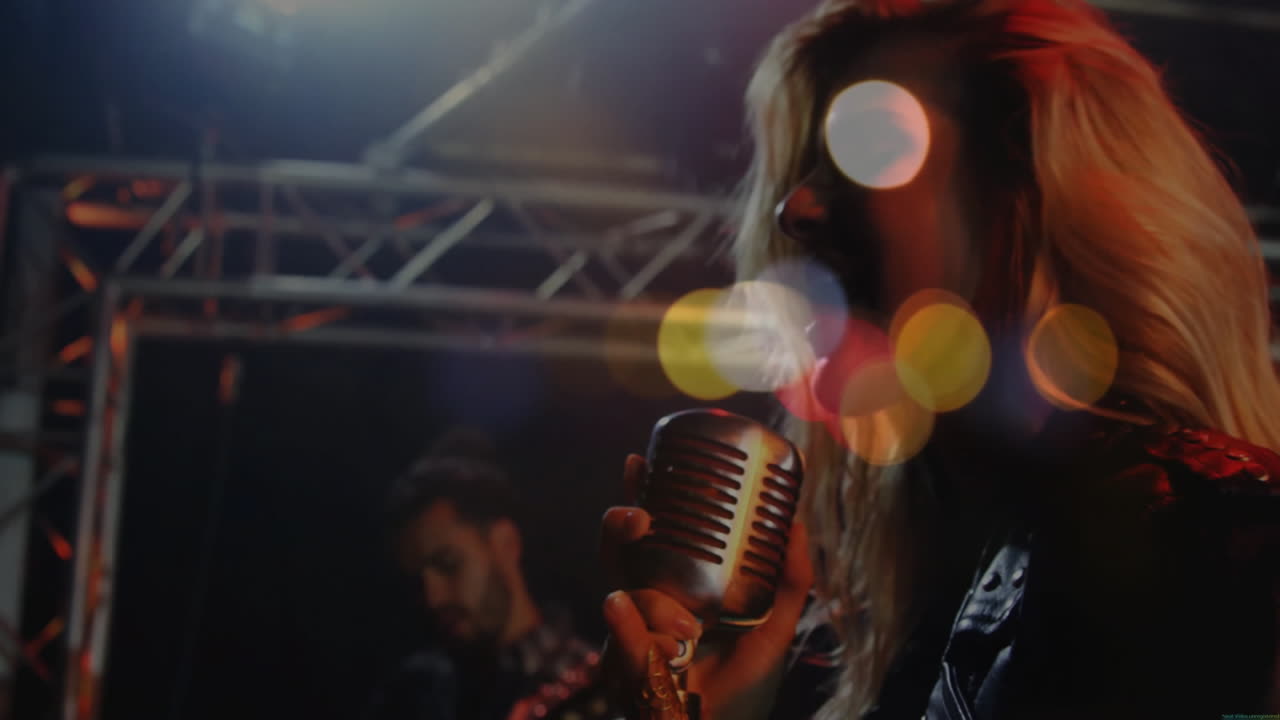 female singer performing on concert stage, with animated bokeh light spots driving music insights