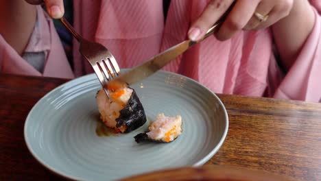 woman eating a dim sum dish