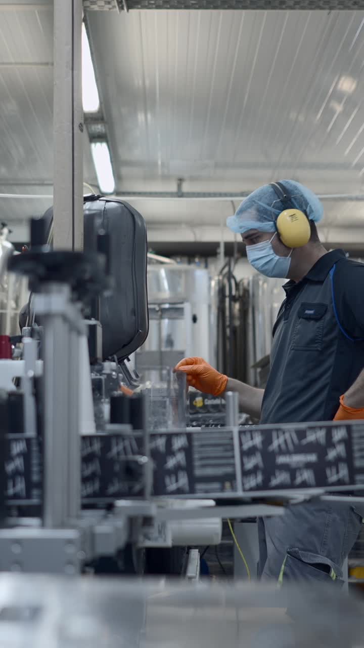 Worker in Personal Protective Equipment at a Manufacturing Plant