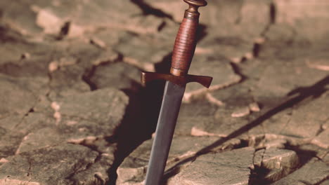 excalibur sword in rocky stone at sunset