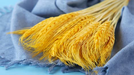 dried wheat bouquet on blue fabric