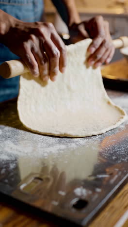 hands making pizza dough