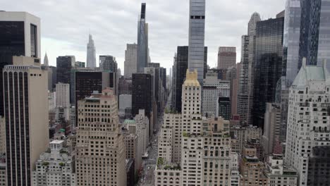 aerial view of the 6th ave of the americas, in cloudy new york, usa - tracking, drone shot